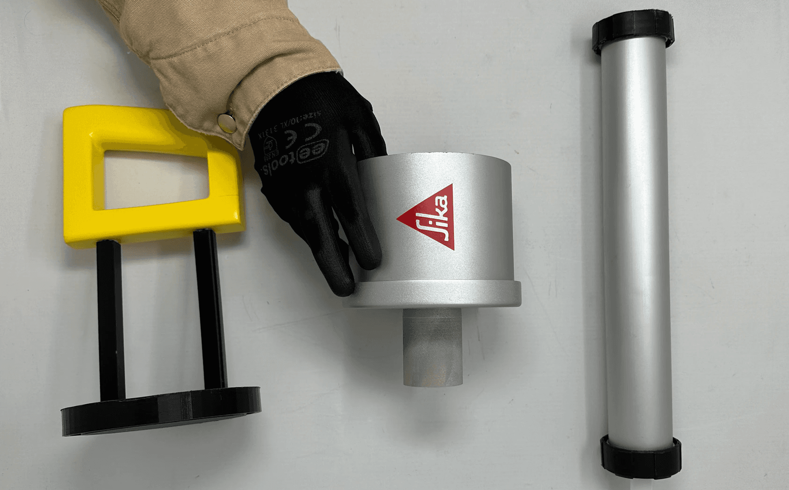 Air Pump Sika Flex Gun with yellow palm-fitting handle next to a Sika cartridge